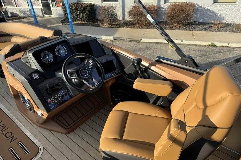 Slide: The Image of Interior of 2026 Avalon 2585 25 Catalina ENT boat with tan seating and modern dashboard. - 11