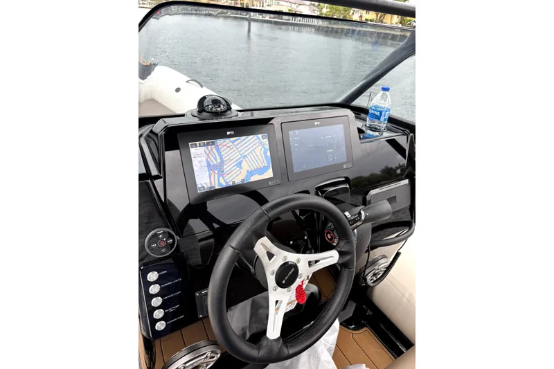Slide: The Image of Cockpit of 2025 Brig NAVIGATOR22 boat with navigation screens and steering wheel. - 10