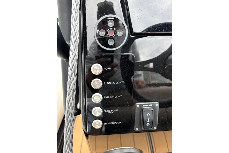 Slide: The Image of Control panel of 2025 Brig NAVIGATOR22 boat with various switches and buttons. - 11