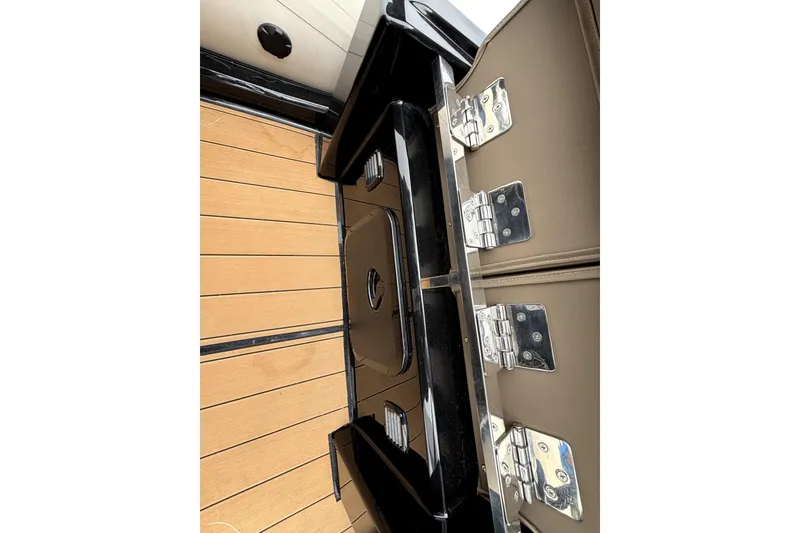 Slide: The Image of 2025 Brig NAVIGATOR22 boat interior with wooden flooring and metal hinges. - 16
