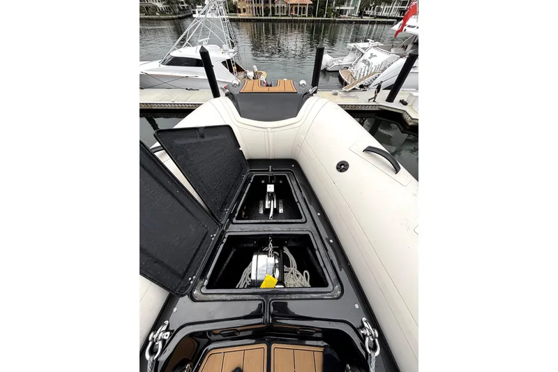 Slide: The Image of 2025 Brig NAVIGATOR22 boat storage compartments open at marina dock. - 21