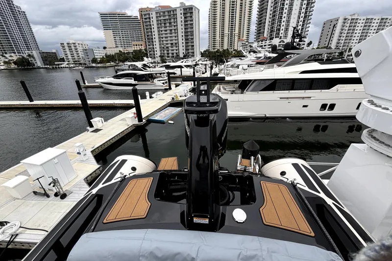 Slide: The Image of 2025 Brig NAVIGATOR22 docked at marina with luxury yachts and city skyline. - 4