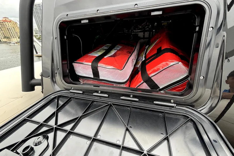 Slide: The Image of Storage compartment of 2025 Brig NAVIGATOR22 boat with red life jackets. - 6