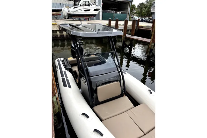 Slide: The Image of 2025 Brig NAVIGATOR22 inflatable boat docked, featuring sleek design and comfortable seating. - 7