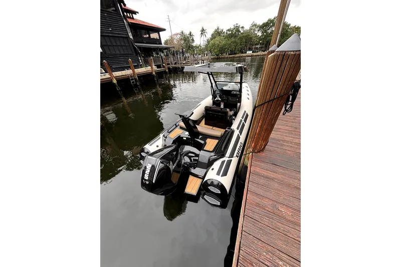 Slide: The Image of 2025 Brig NAVIGATOR22 boat docked, featuring dual engines and sleek design. - 17