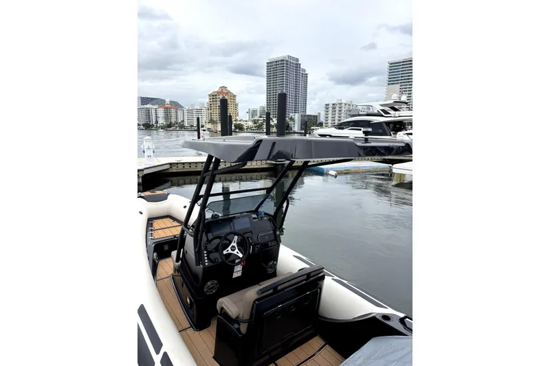 Slide: The Image of 2025 Brig NAVIGATOR22 boat docked in marina with city skyline background. - 20