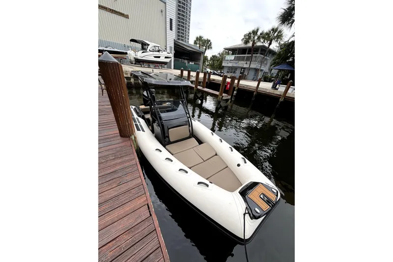 Slide: The Image of 2025 Brig NAVIGATOR22 boat docked, featuring sleek design and spacious seating. - 9