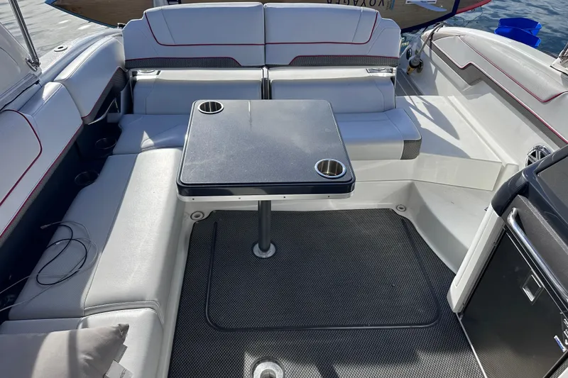 Slide: The Image of 2019 Formula 310 Bowrider interior with seating and table, featuring cup holders. - 13