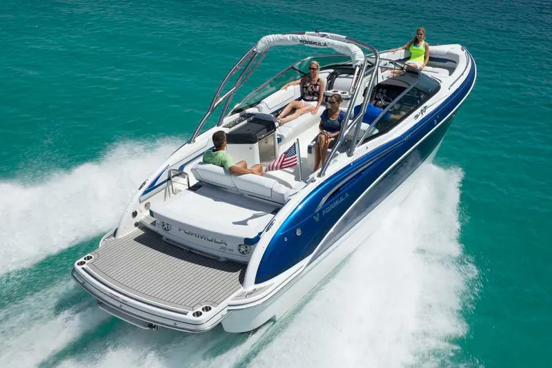 Slide: The Image of 2019 Formula 310 Bowrider docked in a marina, featuring a sleek red design. - 3