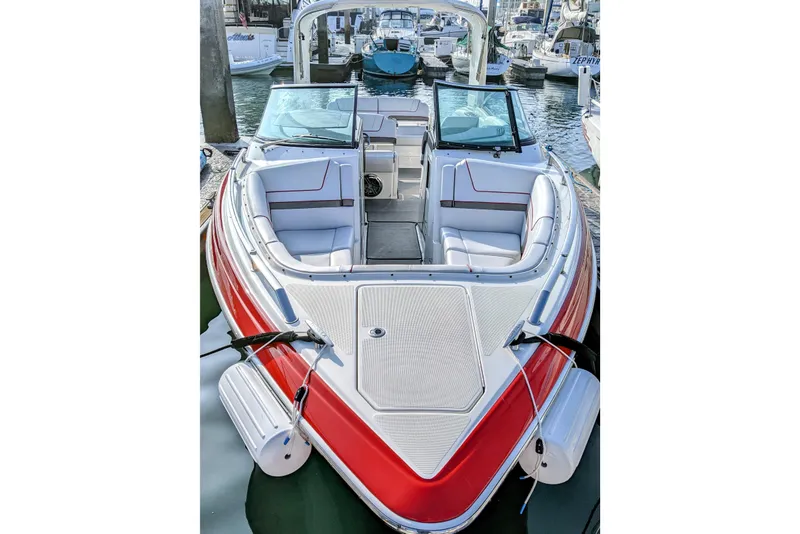 Slide: The Image of 2019 Formula 310 Bowrider boat with red accents docked in marina. - 7