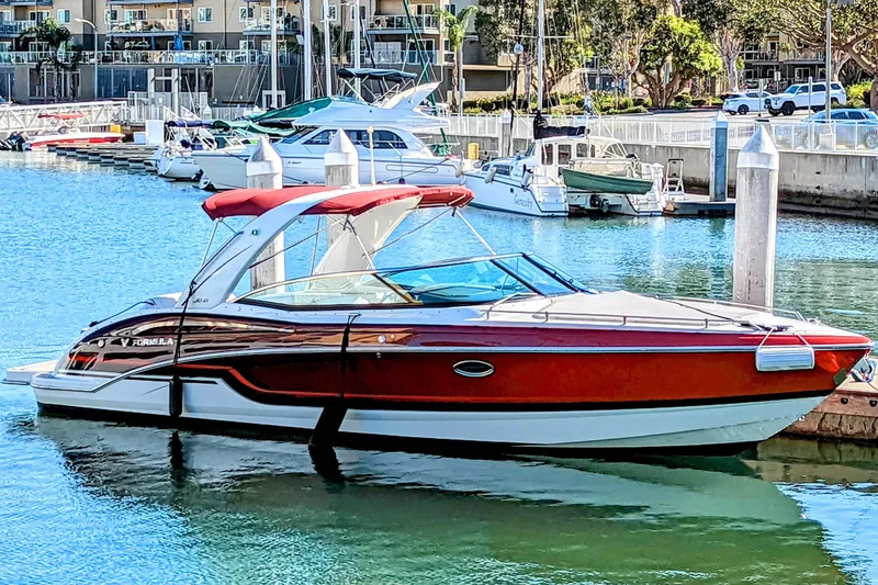 Slide: The Image of 2019 Formula 310 Bowrider boat docked in a marina, featuring sleek design and vibrant colors. - 8