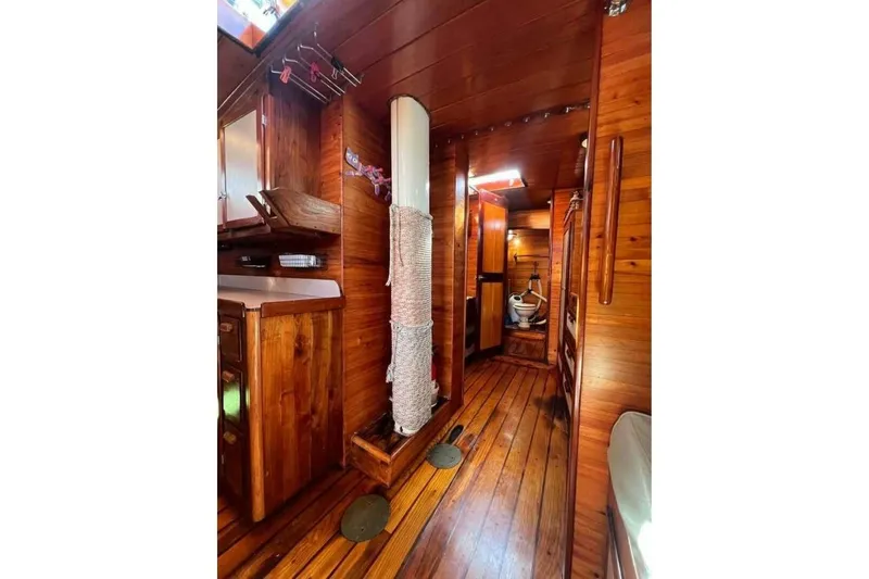 Slide: The Image of Interior of 1993 Custom Baraka 46 boat with wooden paneling and compact design. - 11