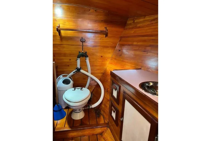 Slide: The Image of Wood-paneled bathroom in 1993 Custom Baraka 46 boat with toilet and sink. - 13