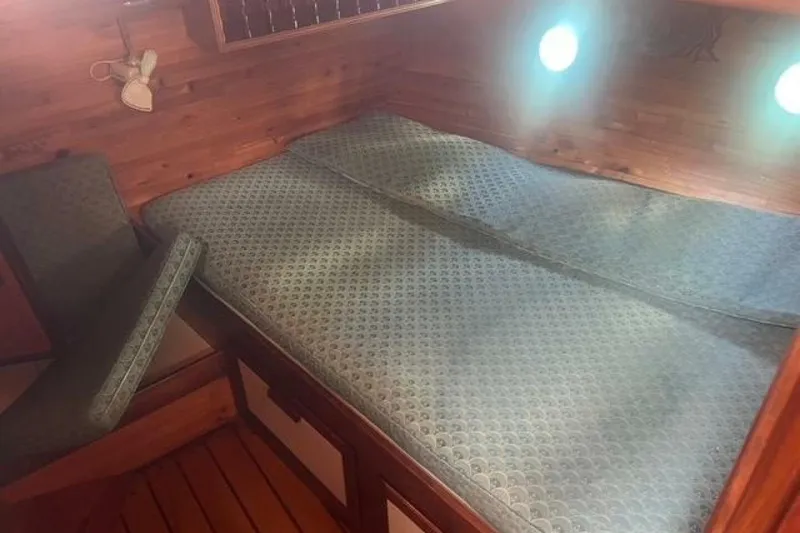 Slide: The Image of Cozy cabin interior of 1993 Custom Baraka 46 yacht with patterned bedding. - 15