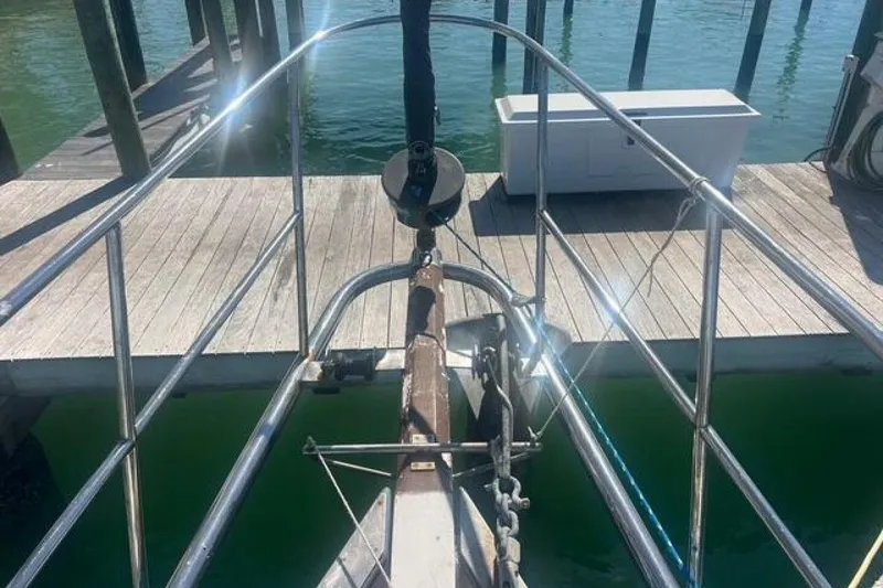 Slide: The Image of Bow of Custom Baraka 46 yacht docked, showing railing and anchor chain, 1993 model. - 18