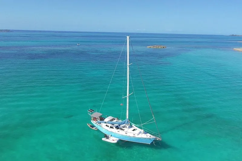 Slide: The Image of Sailboat "Baraka 46" from 1993 on clear turquoise waters. - 2
