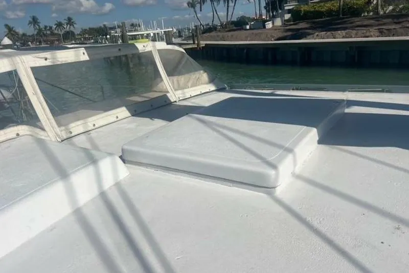 Slide: The Image of Custom Baraka 46 boat deck, 1993 model, with clear skies and waterfront view. - 23