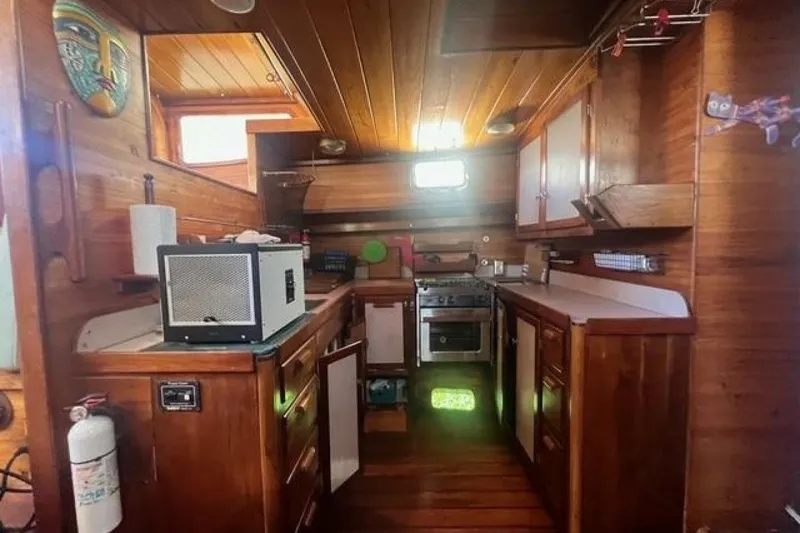 Slide: The Image of Wooden interior of 1993 Custom Baraka 46 yacht kitchen with appliances and decor. - 6