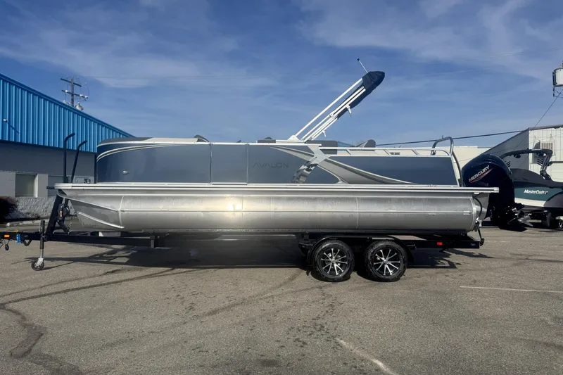 The Image of 2026 Avalon 2385 25 LSZ VRB pontoon boat on trailer, parked outdoors. - 0