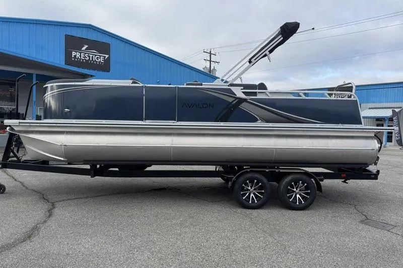 The Image of 2026 Avalon 2385 25 LSZ VRB pontoon boat on trailer at dealership. - 1