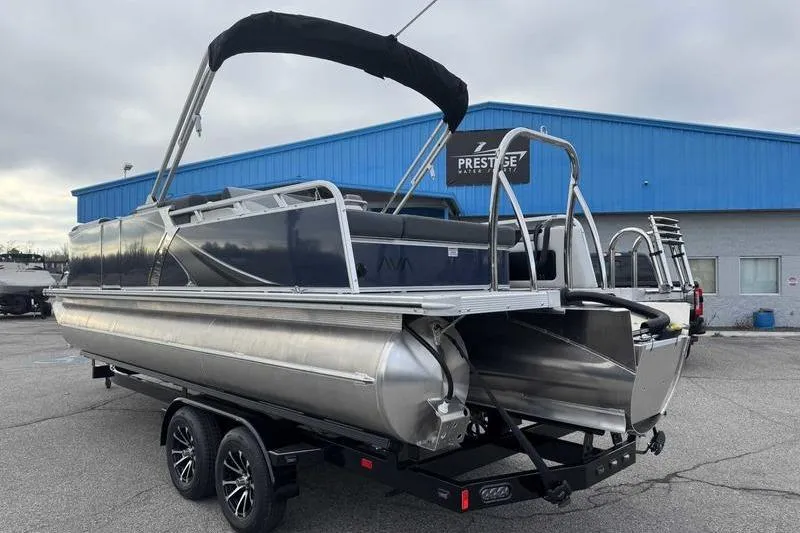 Slide: The Image of 2026 Avalon 2385 25 LSZ VRB pontoon boat on trailer, parked outside dealership. - 7