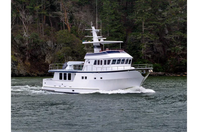 Slide: The Image of 2004 Northern Marine 80' Tri-Deck Expedition yacht cruising near forested shoreline. - 1