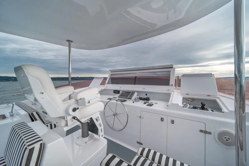 Slide: The Image of Luxurious helm of 2004 Northern Marine 80' Tri-Deck Expedition yacht with striped seating. - 10