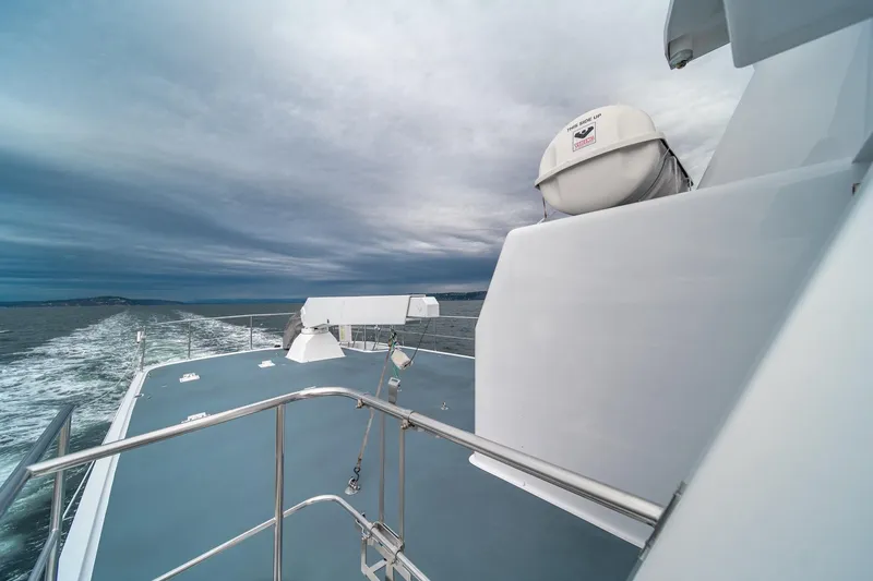 Slide: The Image of Northern Marine 80' Tri-Deck Expedition yacht, 2004, cruising on open water under cloudy skies. - 11