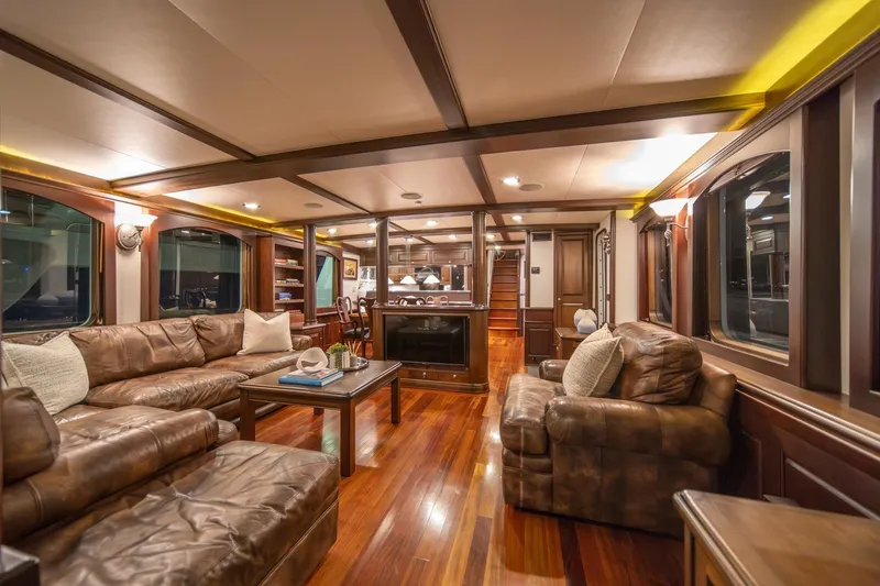 Slide: The Image of Luxurious interior of 2004 Northern Marine 80' Tri-Deck yacht with leather seating and wooden flooring. - 15