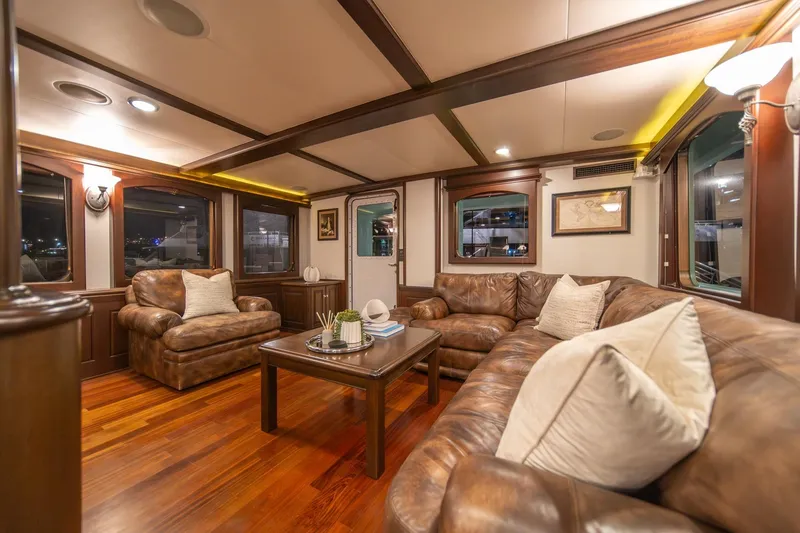 Slide: The Image of Luxurious interior of 2004 Northern Marine 80' Tri-Deck yacht with leather seating and wooden accents. - 16