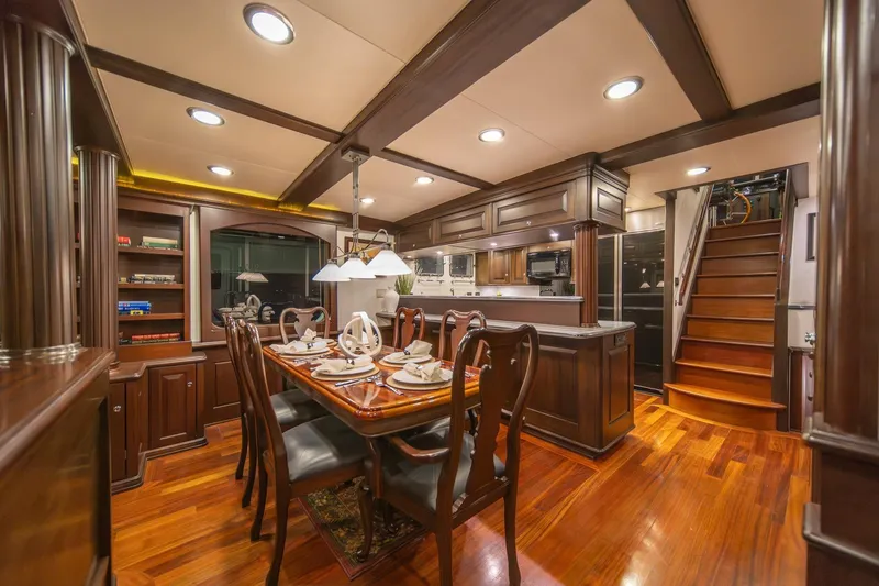 Slide: The Image of Luxurious dining area on 2004 Northern Marine 80' Tri-Deck Expedition yacht, featuring elegant wood finishes. - 19