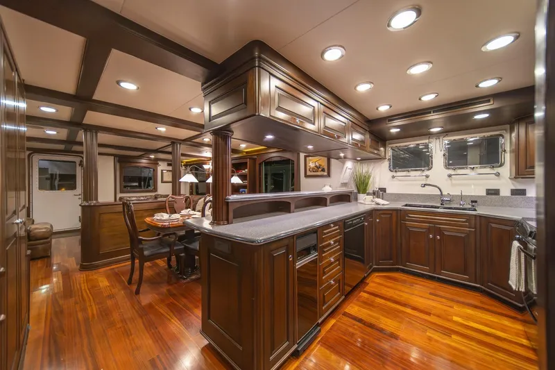 Slide: The Image of Luxurious interior of 2004 Northern Marine 80' Tri-Deck yacht with elegant wood finishes and modern kitchen. - 21