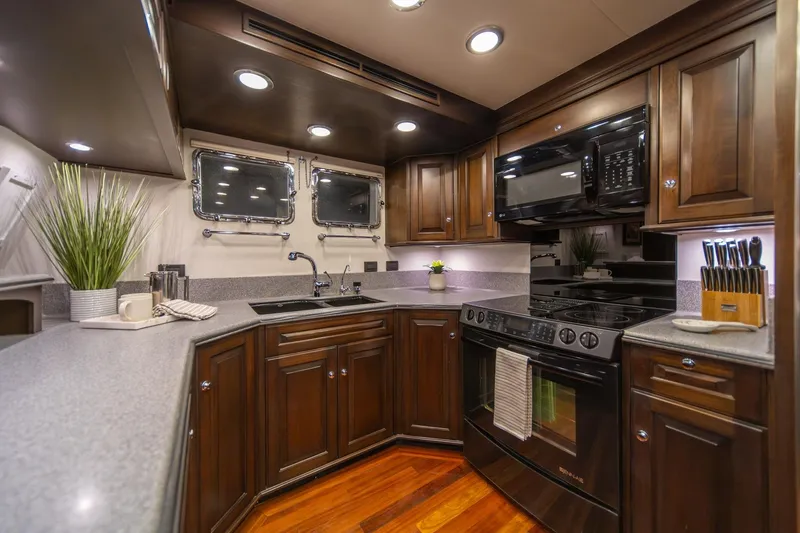Slide: The Image of Luxurious kitchen in 2004 Northern Marine 80' Tri-Deck Expedition yacht, featuring modern appliances and elegant cabinetry. - 24