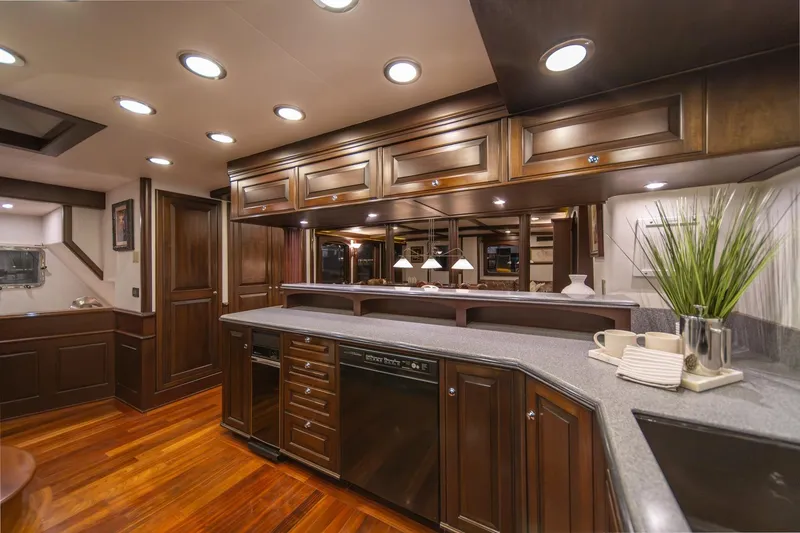 Slide: The Image of Luxurious kitchen interior of 2004 Northern Marine 80' Tri-Deck Expedition yacht with elegant wood cabinetry. - 25