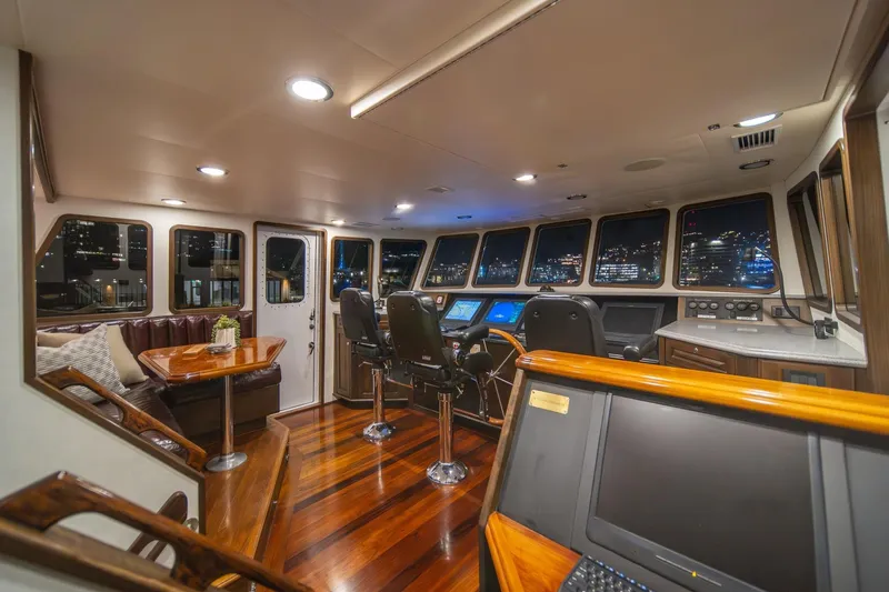 Slide: The Image of Luxurious interior of 2004 Northern Marine 80' Tri-Deck yacht with polished wood and modern controls. - 27