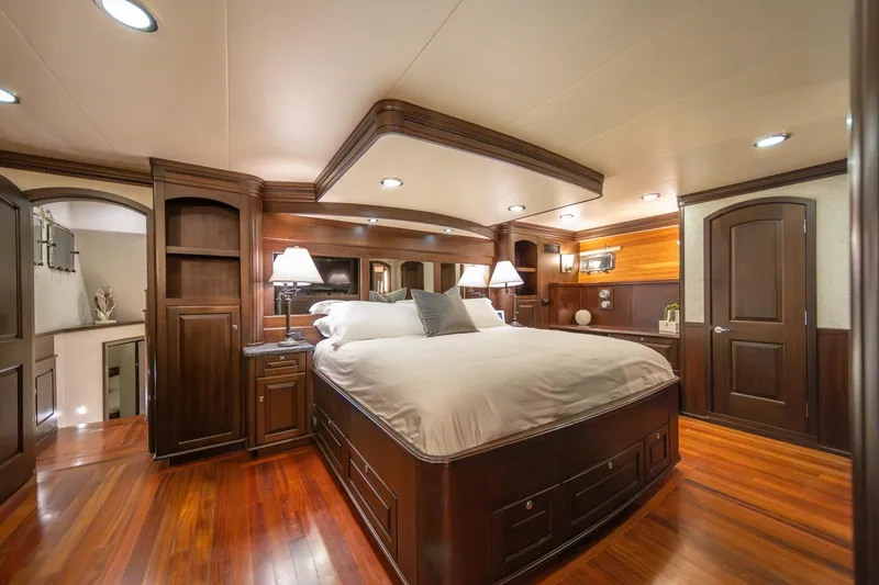 Slide: The Image of Luxurious bedroom interior on 2004 Northern Marine 80' Tri-Deck Expedition yacht, featuring elegant wood finishes. - 34