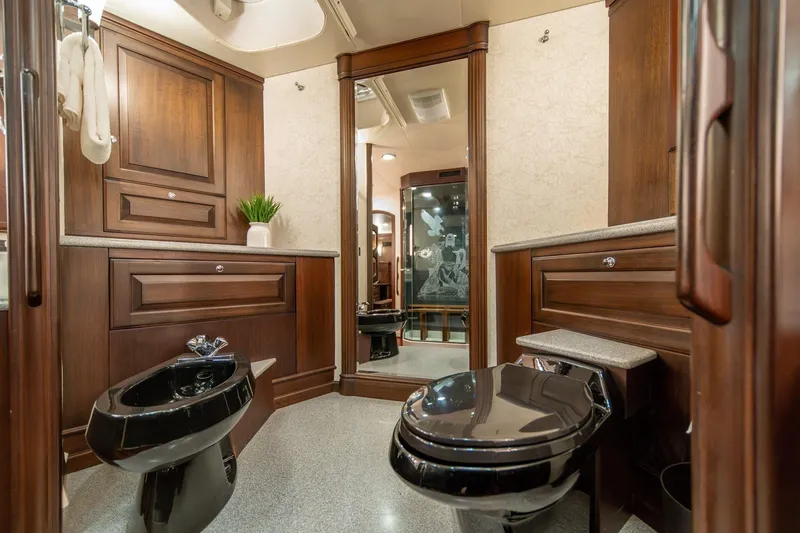Slide: The Image of Luxurious bathroom with dark wood cabinetry on a 2004 Northern Marine 80' Tri-Deck yacht. - 38