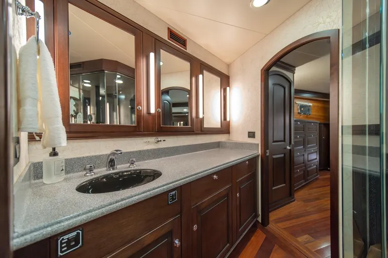 Slide: The Image of Luxurious bathroom in 2004 Northern Marine 80' Tri-Deck Expedition yacht, featuring elegant wood cabinetry. - 40