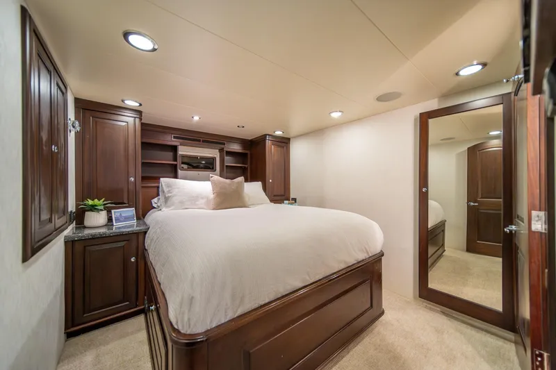 Slide: The Image of Luxurious bedroom in 2004 Northern Marine 80' Tri-Deck Expedition yacht, featuring elegant wood cabinetry. - 43