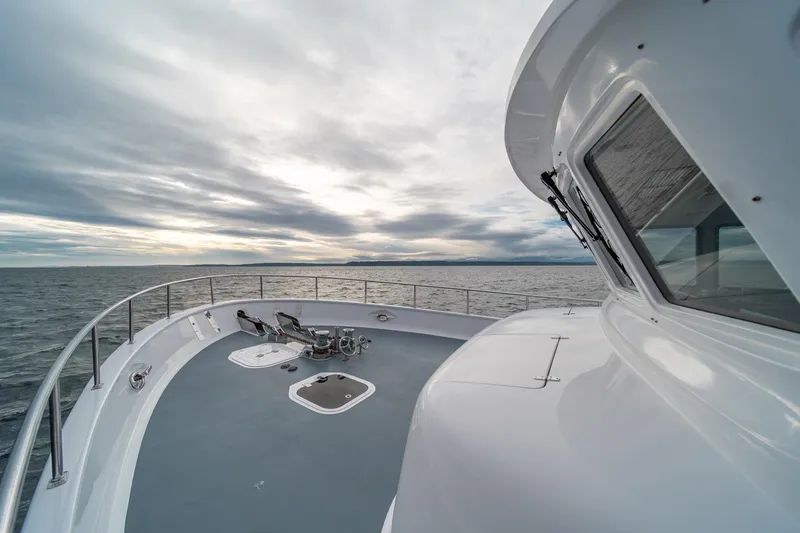 Slide: The Image of Northern Marine 80' Tri-Deck Expedition yacht, 2004, on open sea under cloudy sky. - 5