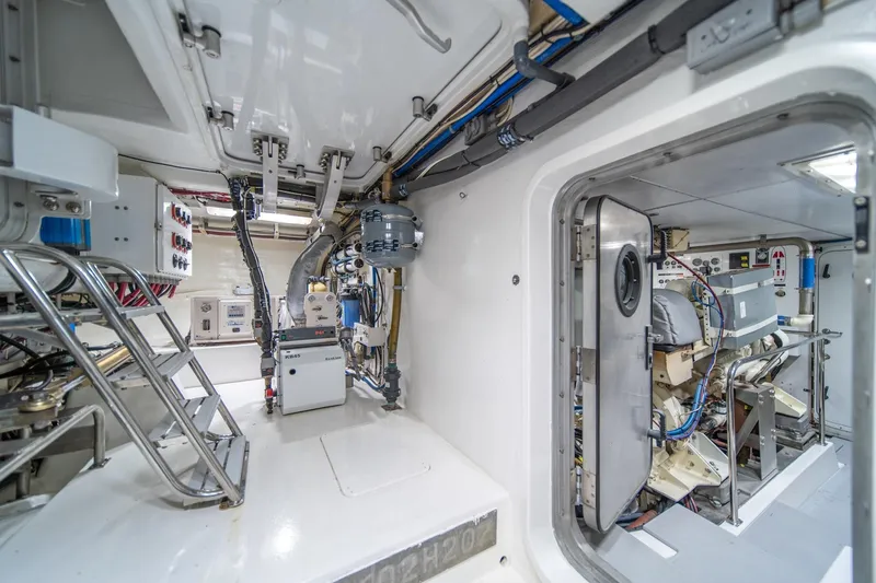 Slide: The Image of Engine room of 2004 Northern Marine 80' Tri-Deck Expedition yacht, showcasing equipment and controls. - 58