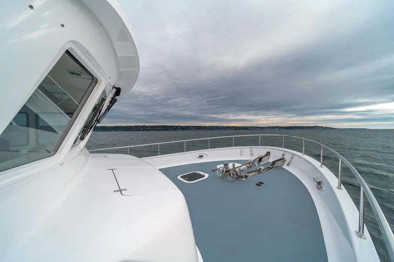 Slide: The Image of Northern Marine 80' Tri-Deck Expedition yacht, 2004, cruising on open water under cloudy skies. - 6