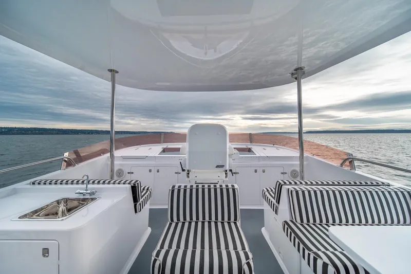 Slide: The Image of Luxurious 2004 Northern Marine 80' Tri-Deck yacht with striped seating and ocean view. - 7