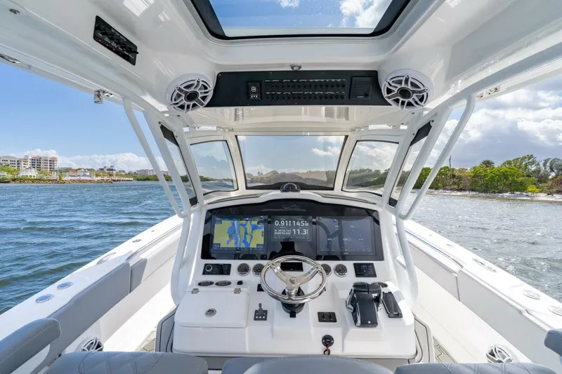 Slide: The Image of 2023 Blackwater High-Performance boat cockpit with advanced navigation system, steering wheel, and ocean view. - 10