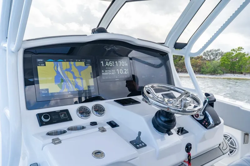 Slide: The Image of 2023 Blackwater High-Performance boat dashboard with navigation screens and steering wheel. - 20