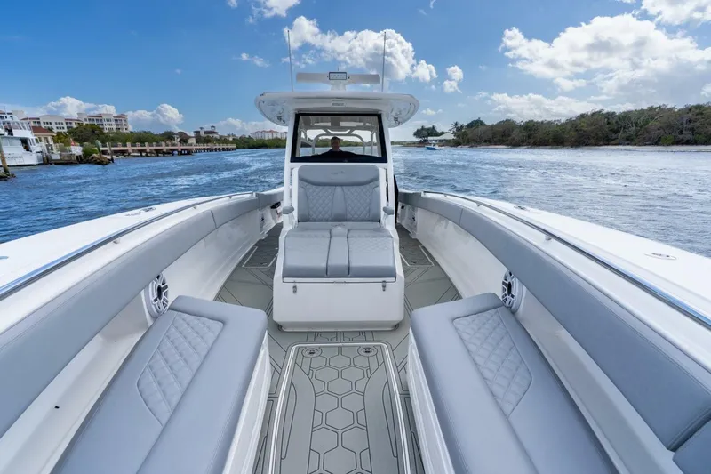 Slide: The Image of 2023 Blackwater High-Performance boat interior on a sunny day, cruising on a scenic waterway. - 23