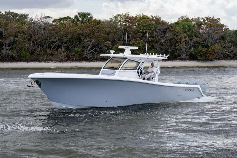 Slide: The Image of 2023 Blackwater High-Performance boat cruising near a forested shoreline. - 3