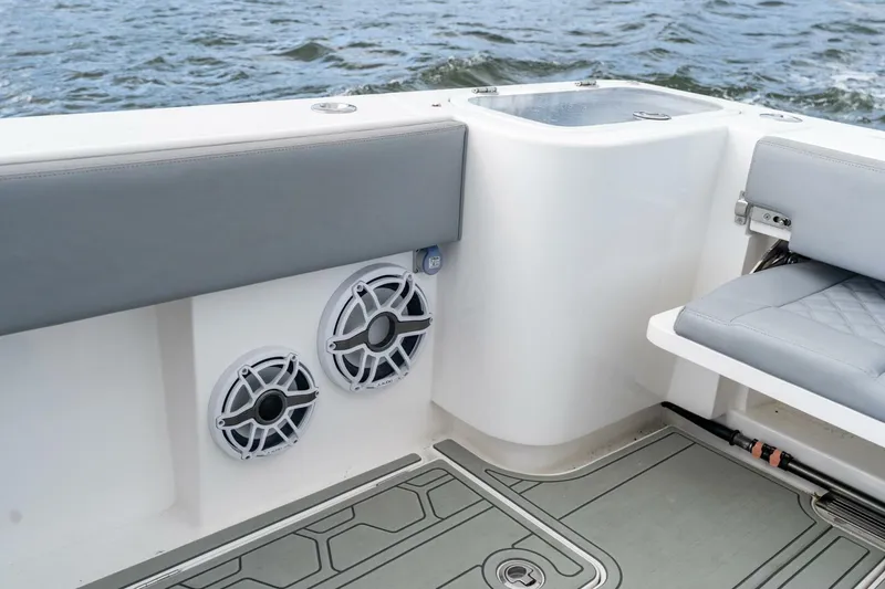 Slide: The Image of 2023 Blackwater High-Performance boat interior with speakers and seating, on water. - 30