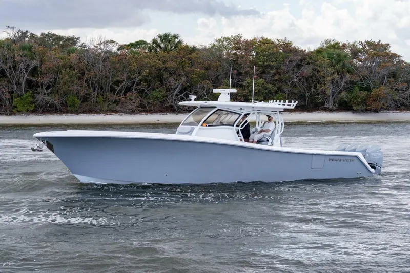 Slide: The Image of 2023 Blackwater High-Performance boat cruising near a forested shoreline. - 4