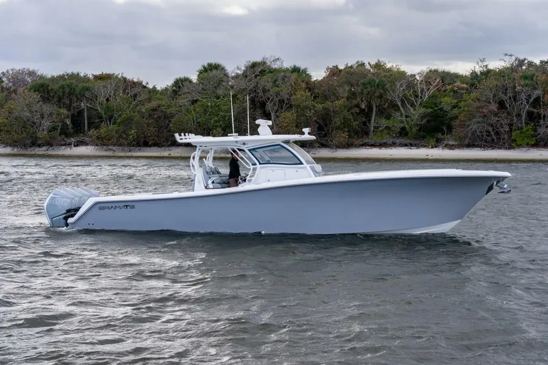 Slide: The Image of 2023 Blackwater High-Performance boat cruising near a forested shoreline. - 5